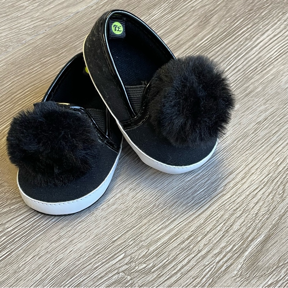 Black baby girl Pom Pom slip ons